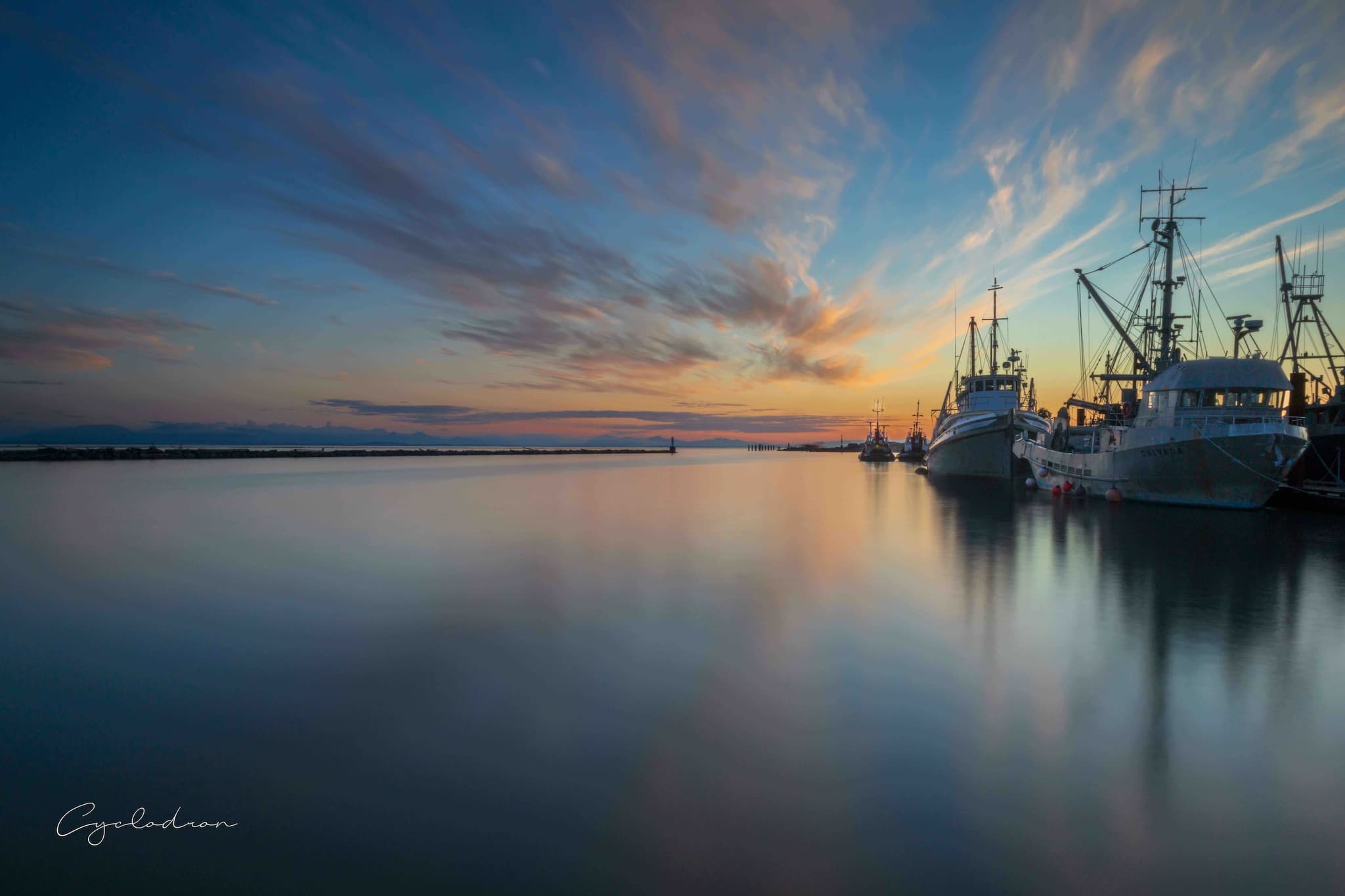 Harbor sunset with fishing boats at blue hour
